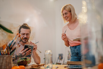 Creative artist smiling and preparing for painting at artistic studio.