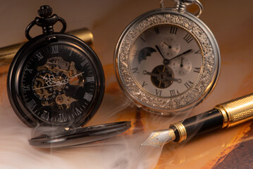 Beautiful pocket watch and vintage fountain pen on rustic wood, selective focus.