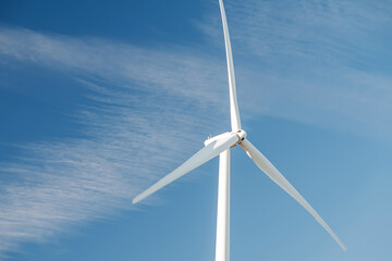 Wind power turbine over the blue sky