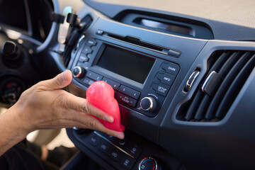 Clean car air vents efficiently with soft pink gel for innovative interior detailing