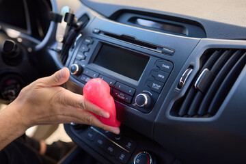 Fototapeta premium Clean car air vents efficiently with soft pink gel for innovative interior detailing