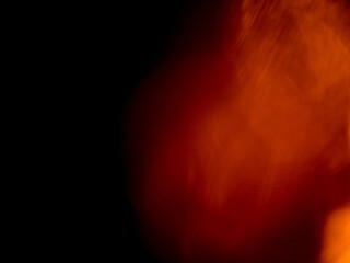 Light orange warm color light leak on dark background for design use and special effects.