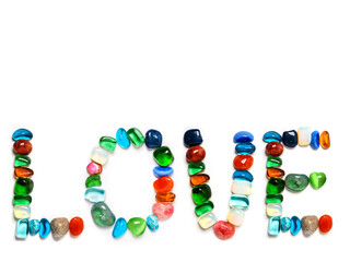 Sign love on white background made from colorful gems. Copy space. Natural art.