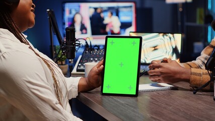 Green screen tablet hold by woman on podcast discussing with guest during marathon stream for...