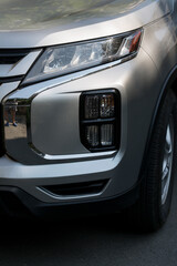 Leftist front wheel and headlight. Replicas of Russian cars. Halogen lighting at the gray car.