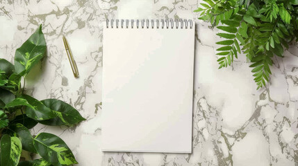 Photo of blank notepad mockup on marble background with green leaves and pen, top view. Mock up template for creative work or decoration idea
