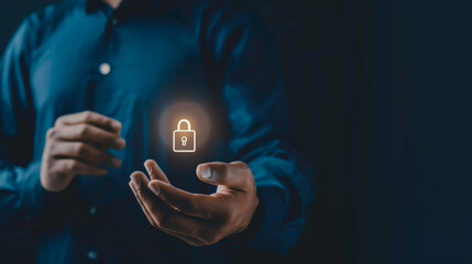 Close-up of a businessman holding a badge GDPR in his hand on a dark background. Hands of a man holding a safety icon indoors. Copy space.
