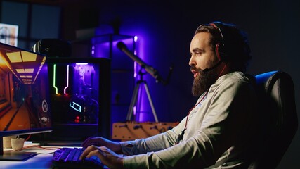 Man playing science fiction FPS videogame with friends, having fun in dark apartment room. Gamer...