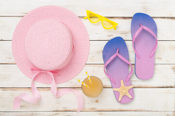 Flat lay with colorful beach accessories on wooden background. Vacation concept