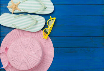 Flat lay with colorful beach accessories on wooden background. Vacation concept