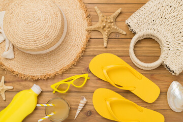 Flat lay with colorful beach accessories on wooden background. Vacation concept