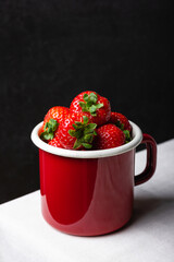Strawberries in enamel mug