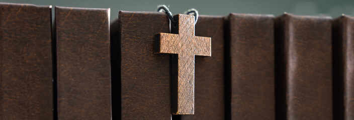 Necklace with wooden cross on books, Christian concept, religious symbol