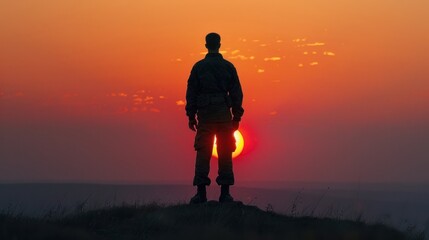 Soldier silhouette at sunset, standing on battlefield, representing courage and sacrifice in modern warfare