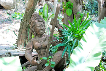 An Ancient Statue Surrounded by Abundant Green Foliage, Reflecting Rich Cultural Heritage
