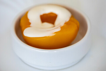 Traditional dessert of peaches in syrup with cream