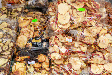 A pile of apples in plastic bags, dried fruits