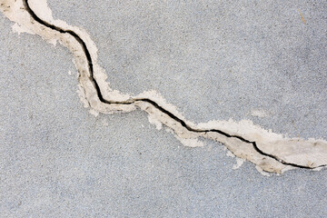 A crack in the concrete is visible