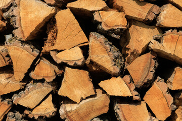 A pile of wood logs with a lot of bark on them