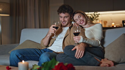 Relaxed couple celebrate anniversary at evening apartment couch close up.