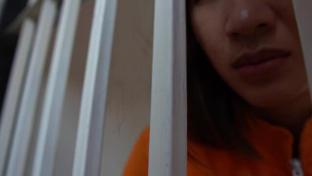 Female prisoner locked in jail,Being the scapegoat for a case that wasn't done,want freedom from captivity,Asian woman very sad and stressed