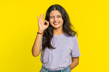 Okay. Happy Indian woman looking approvingly at camera showing ok gesture like sign positive...