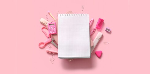 Composition with blank notebook and different school stationery on pink background