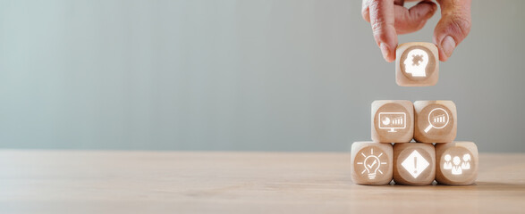 Problem solving concept, Hand holding wooden block on desk with Problem solving icon on virtual...