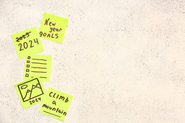Sticky notes with different goals for 2024 on grunge white background
