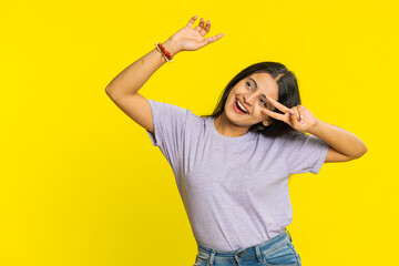 Happy smiling Indian woman listening music and dancing disco fooling around having fun expressive...