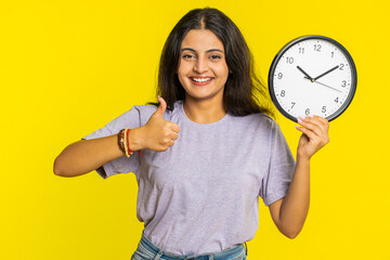It is your time, hurry up. Indian woman showing time on wall office clock, ok, thumb up, approve,...