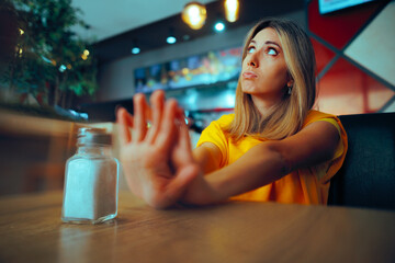 Health-Conscious Woman Refusing to Add More Salt. Restaurant customer living a salt-free diet...