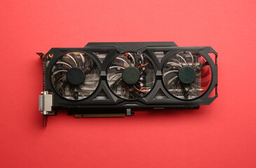 One graphics card on red background, top view