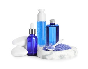 Spa composition. Bottles of cosmetic products, stones and sea salt isolated on white