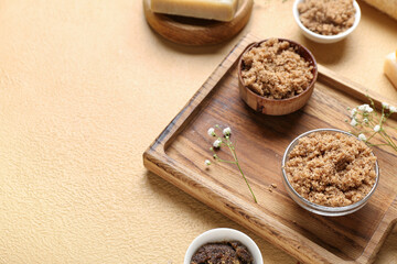 Wooden board with natural body scrubs on color background