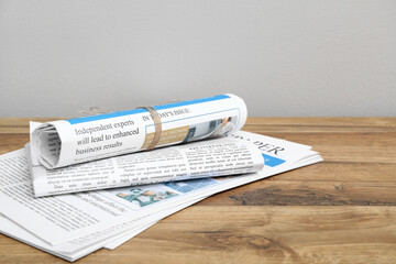 Daily newspapers on wooden table