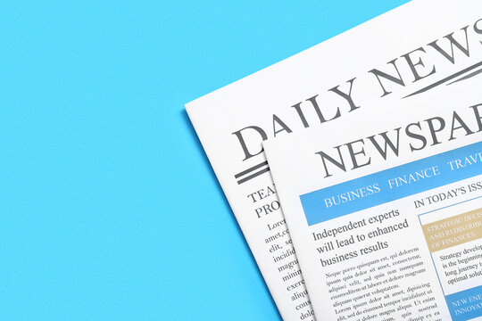 Different newspapers on blue background