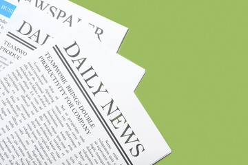 Naklejka premium Different newspapers on green background