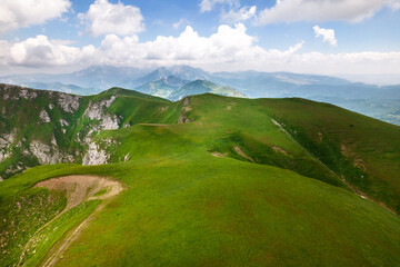 Obraz premium Beautiful day over the mountain range at Bosnia and Herzegovina. Wonderful summer landscape in mountains. Grassy field and rolling hills.