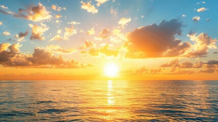 Obraz premium Stunning sunset over ocean with clouds reflecting on water