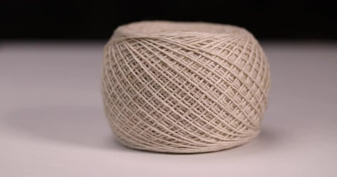 a spool of light thread for sewing, a skein of thread for knitting and sewing objects