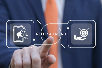 Business man using virtual screen presses text: REFER A FRIEND. Referral marketing or affiliate...