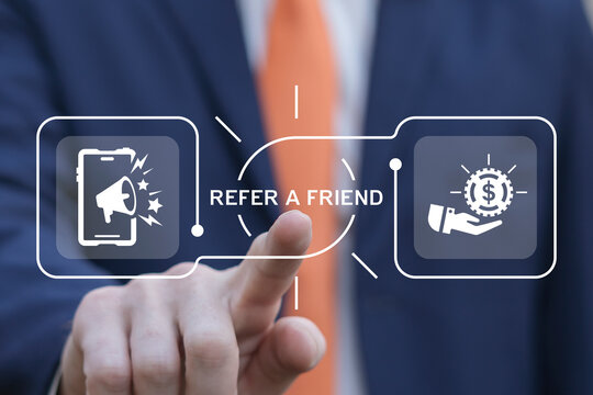 Business man using virtual screen presses text: REFER A FRIEND. Referral marketing or affiliate marketing concept. Invite friends to refer a friend loyalty program to win online reward. Refer and earn
