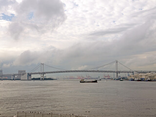 Rainbow Bridge and Tokyo bay view with cargo ship under the bridge