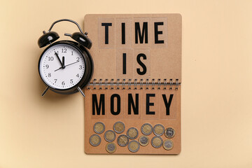 Notebook with text TIME IS MONEY and alarm clock on beige background. Top view