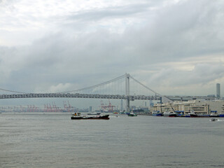 Rainbow Bridge and Tokyo bay view with cargo ship under the bridge