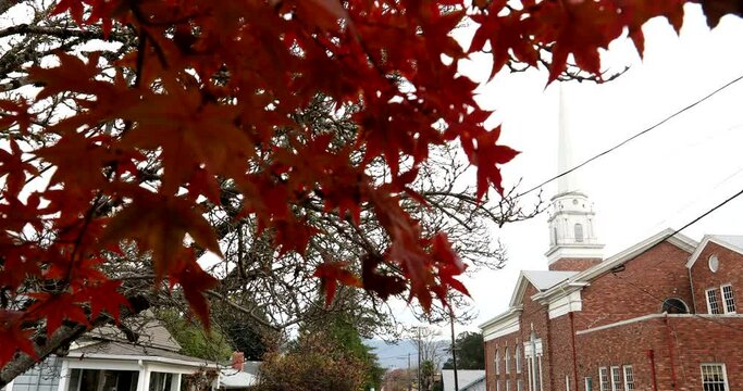 Aumtum cloudy light and foliage frame homes and a church building in downtown Ukiah, California, USA.