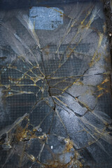 Broken Glass Window With Rusted Metal Grate