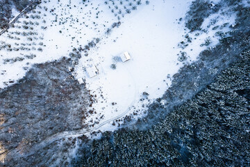 Aerial view of a winter landscape. Snow-covered forest. Winter forest texture. Aerial view. Aerial drone view of a winter landscape. Snow covered forest.