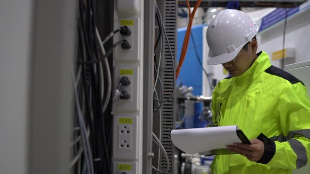 Electrical engineer inspects high-voltage electrical cabinet,Technician maintains the factory's electricity meter.
